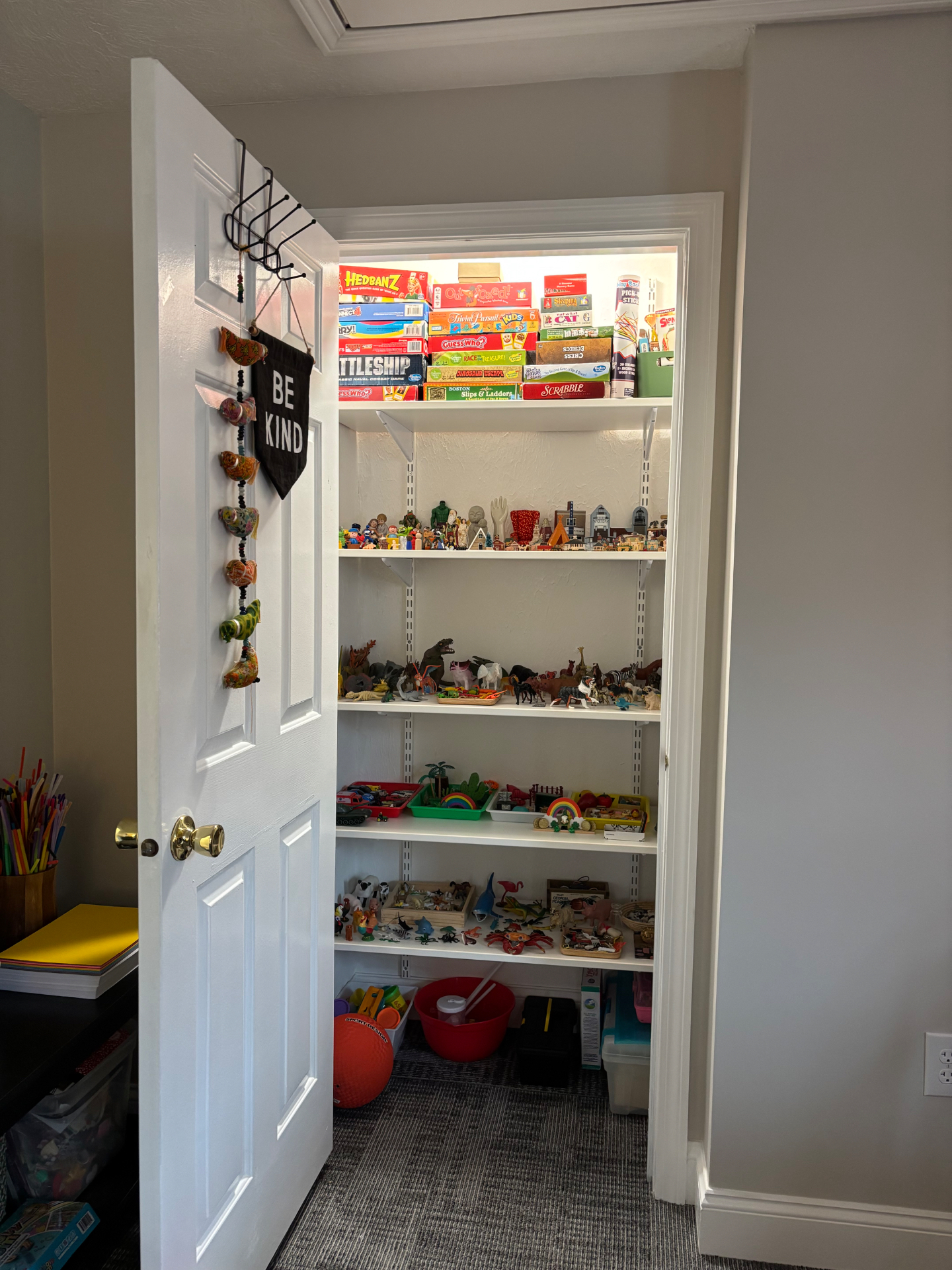 Play therapy closet with games, toys, and sand tray figurines