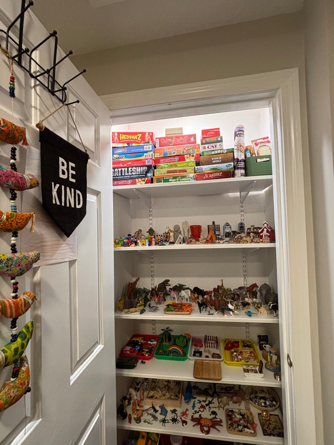 Closet shelves with play therapy figurines, animals, and miniatures