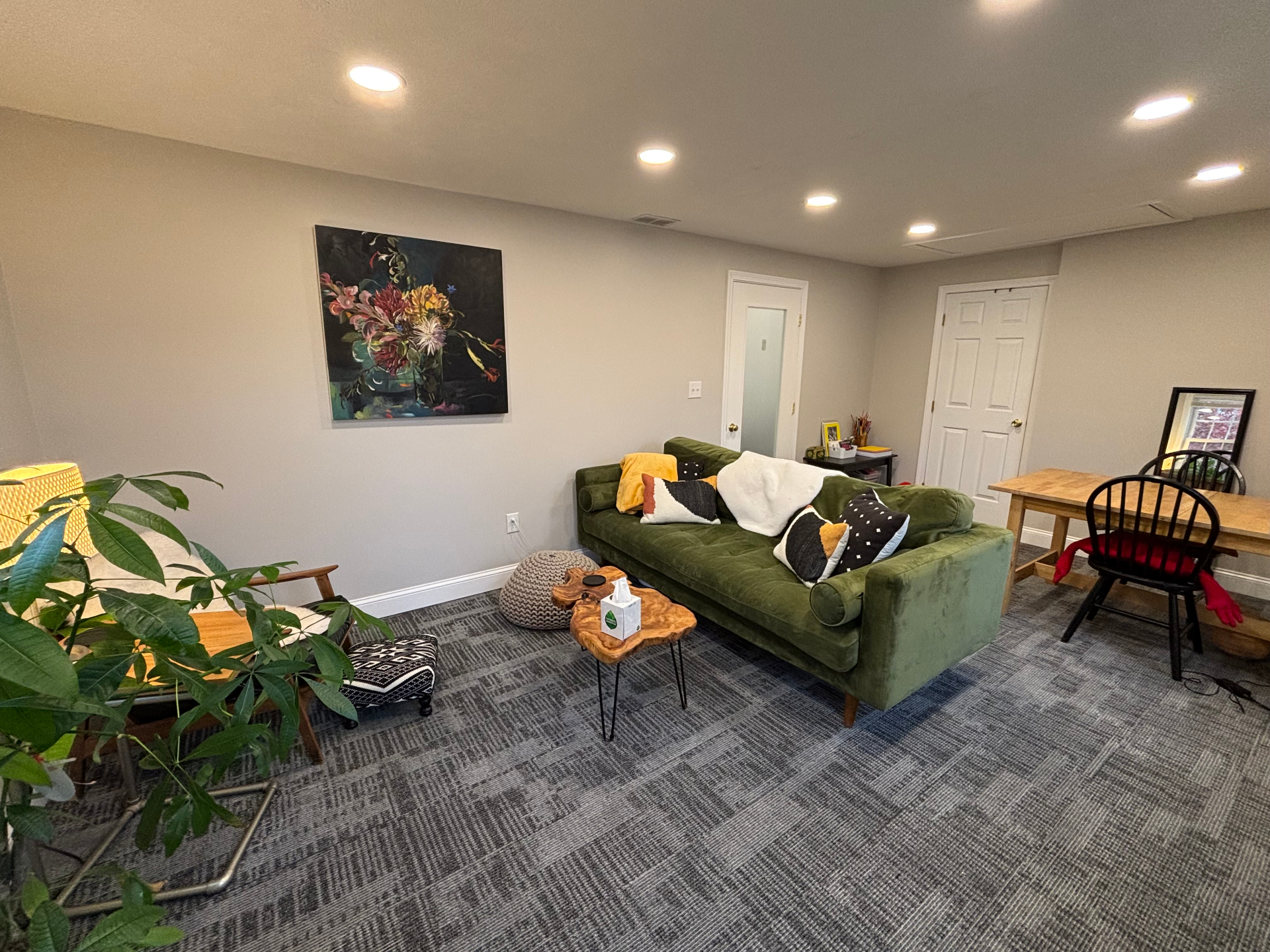 Full office view with sofa, artwork, and natural light